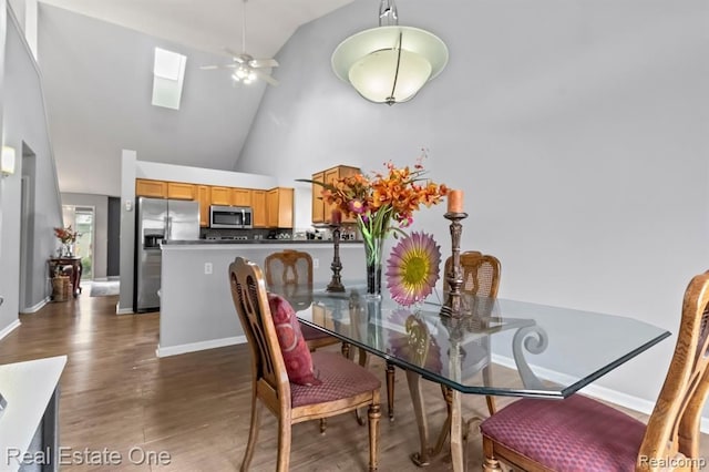 45089 Klingkammer St, Utica, MI 48317 - dining area featuring wood finished floors, baseboards, high vaulted ceiling, a ceiling fan, and a skylight