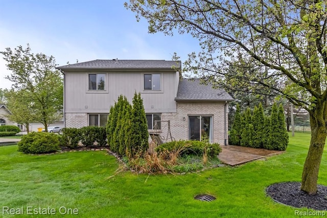 45089 Klingkammer St, Utica, MI 48317 - rear view of house with a lawn and brick siding