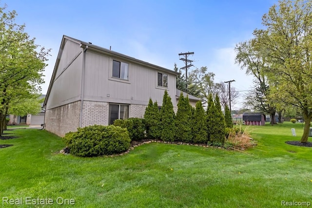 45089 Klingkammer St, Utica, MI 48317 - view of side of property with a lawn and brick siding