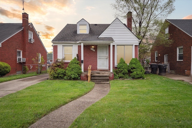 11908 Roxbury St, Detroit, MI 48224 - view of front of property with a shingled roof, a yard, brick siding, and cooling unit