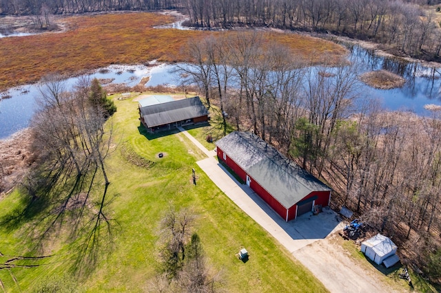 birds eye view of property featuring a wooded view and a water view