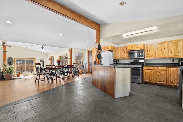 kitchen with lofted ceiling with beams, dark countertops, stainless steel appliances, and recessed lighting