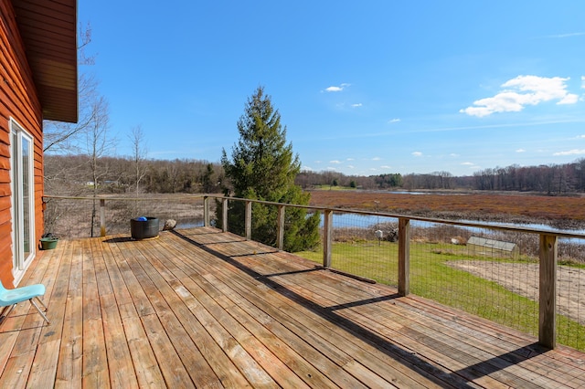 wooden terrace featuring a lawn and a water view