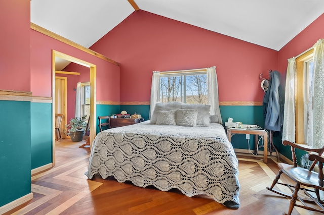 bedroom featuring wood finished floors, vaulted ceiling, and baseboards