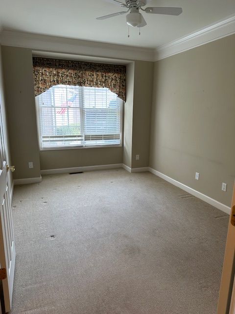 5081 Belmonte Dr, Rochester, MI 48306 - carpeted spare room featuring a ceiling fan, baseboards, and crown molding