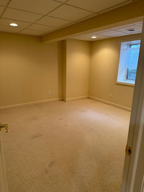 5081 Belmonte Dr, Rochester, MI 48306 - spare room with light colored carpet, baseboards, and a paneled ceiling