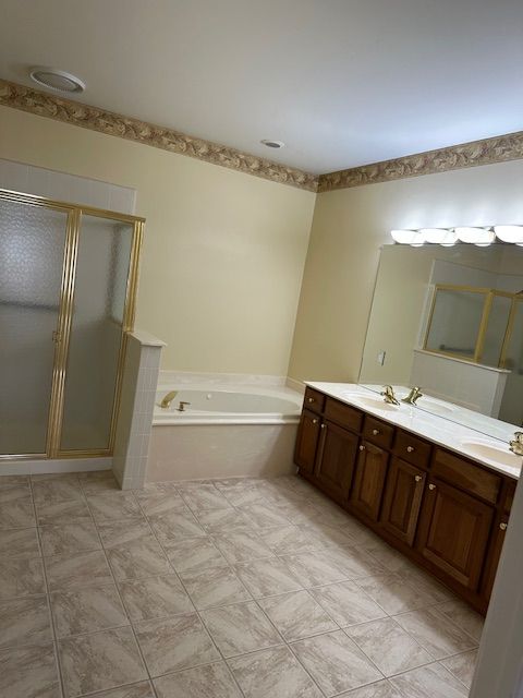 5081 Belmonte Dr, Rochester, MI 48306 - full bathroom with a bath, a sink, double vanity, and a stall shower