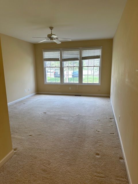 5081 Belmonte Dr, Rochester, MI 48306 - carpeted spare room with plenty of natural light, baseboards, and ceiling fan