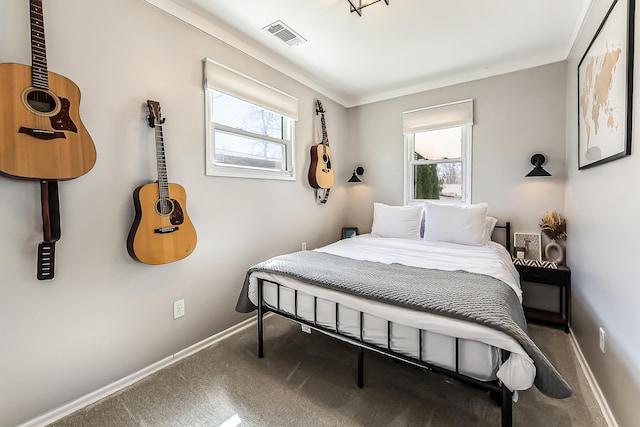 bedroom featuring baseboards, multiple windows, visible vents, and carpet