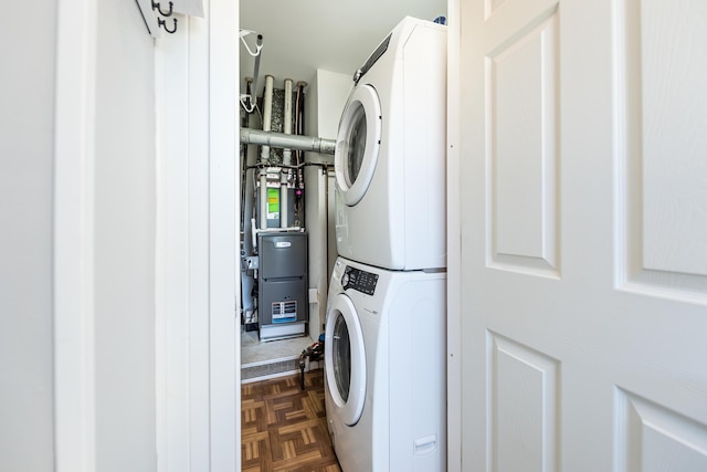 washroom with stacked washer and dryer and laundry area