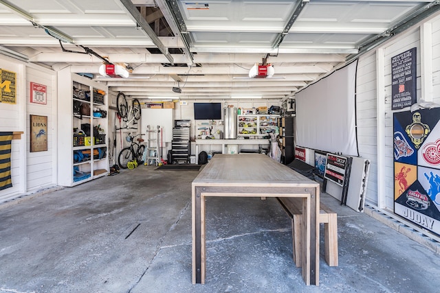 garage with a garage door opener and a workshop area