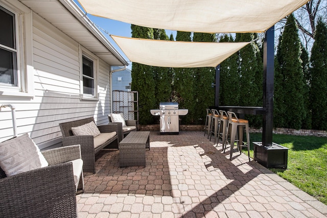 view of patio with outdoor dry bar, a grill, and an outdoor living space