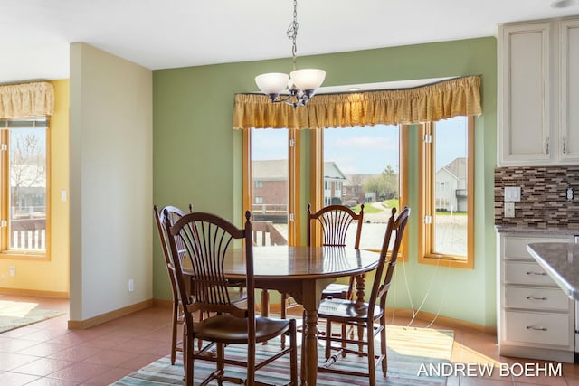 332 Royal Park Dr, Zeeland, MI 49464 - dining area featuring light tile patterned flooring, plenty of natural light, baseboards, and an inviting chandelier