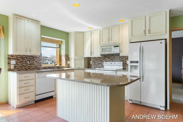 332 Royal Park Dr, Zeeland, MI 49464 - kitchen featuring light tile patterned flooring, backsplash, cream cabinets, and white appliances