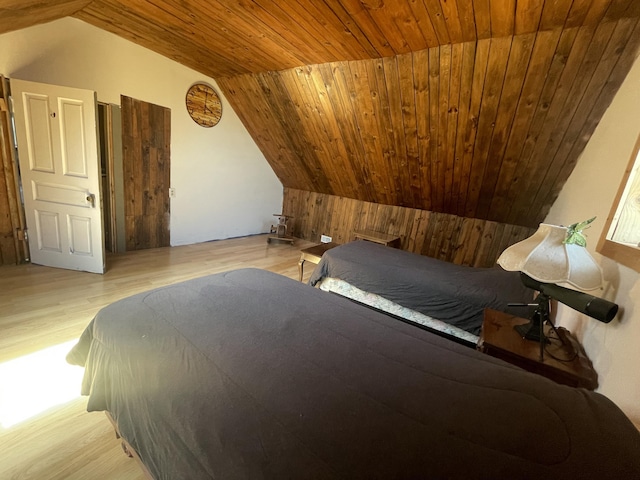 7801 S Lucas Rd, Mcbain, MI 49657 - bedroom featuring wooden walls, lofted ceiling, wooden ceiling, and wood finished floors
