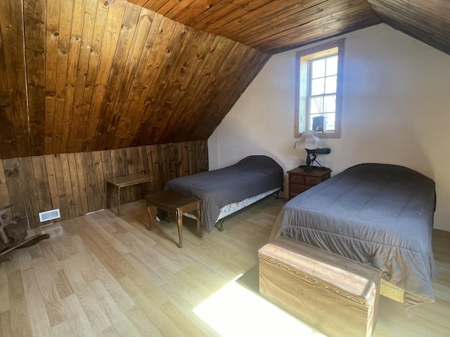 7801 S Lucas Rd, Mcbain, MI 49657 - bedroom featuring lofted ceiling, visible vents, wood finished floors, and wooden walls