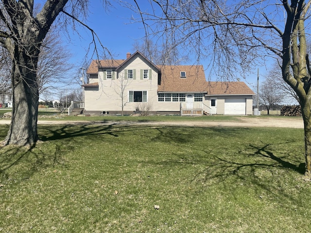 7801 S Lucas Rd, Mcbain, MI 49657 - view of front of house with an attached garage, dirt driveway, a chimney, and a front lawn