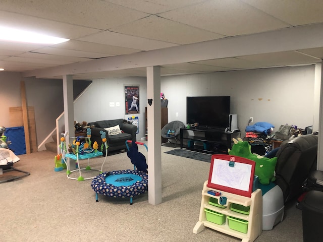 playroom with carpet floors and a drop ceiling