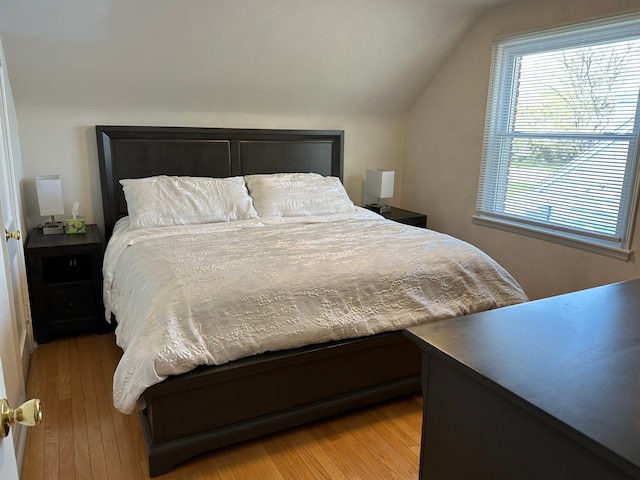 bedroom featuring vaulted ceiling and wood finished floors