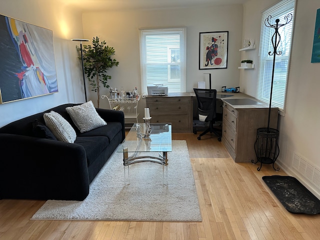 living area featuring visible vents and light wood finished floors