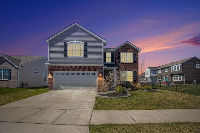 traditional-style house featuring fence, driveway, brick siding, and a garage