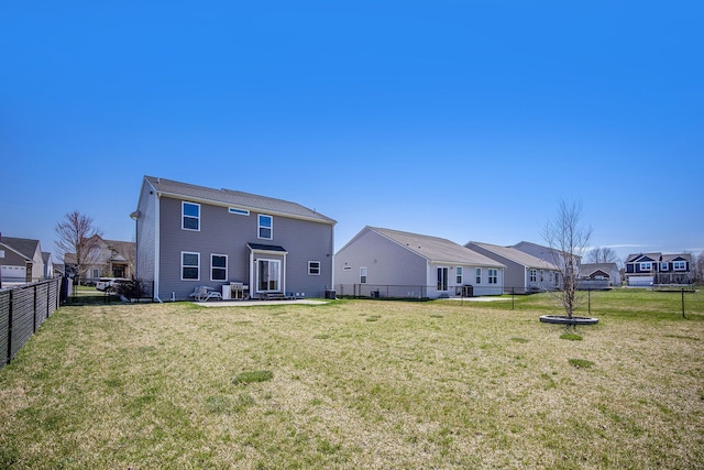 rear view of property with a lawn, a residential view, a patio area, and fence private yard