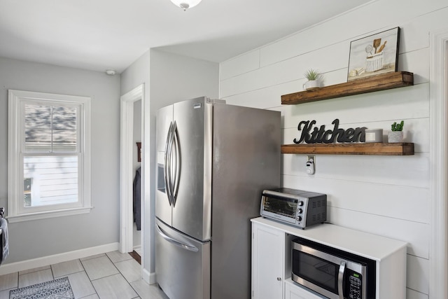 kitchen featuring open shelves, light countertops, stainless steel appliances, baseboards, and a toaster