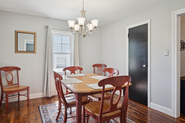 dining area with baseboards, dark wood-style flooring, and a chandelier