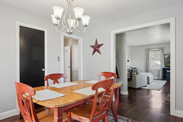 dining space with baseboards and an inviting chandelier