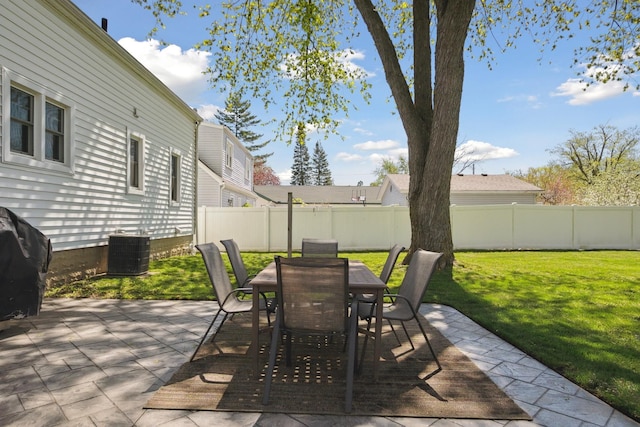 view of patio with a fenced backyard, outdoor dining area, and central AC