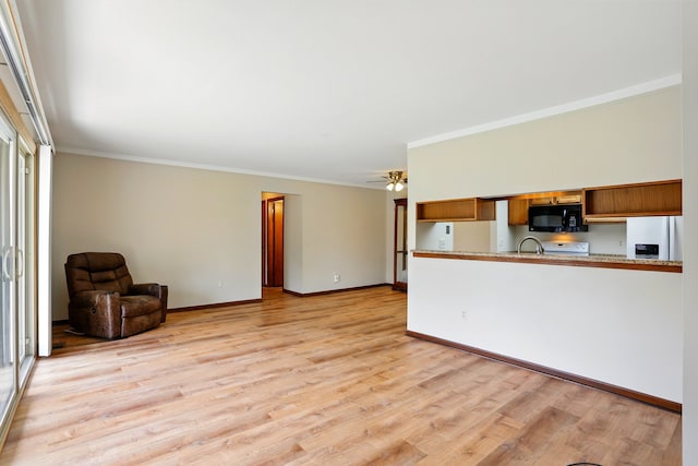 unfurnished living room with light wood finished floors, crown molding, baseboards, and a ceiling fan