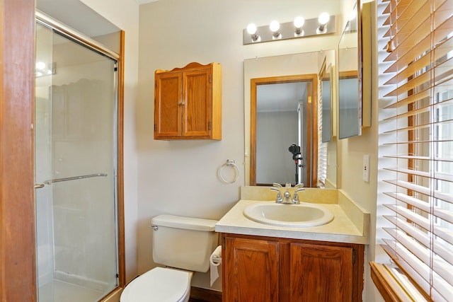 full bathroom featuring vanity, toilet, and a stall shower