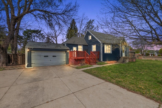 view of front of home featuring driveway, fence, a lawn, and an attached garage