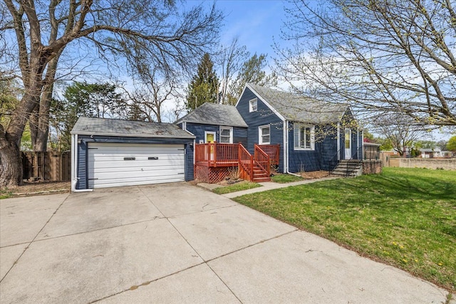 single story home featuring a detached garage, a front lawn, and fence