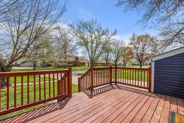 deck featuring a residential view and a yard