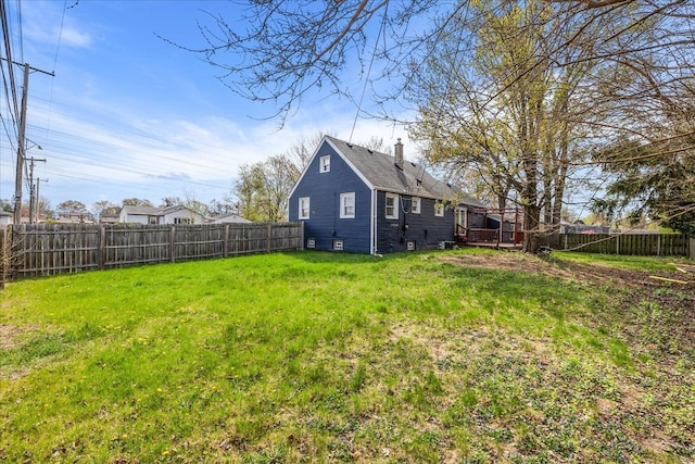 view of yard with a wooden deck and a fenced backyard