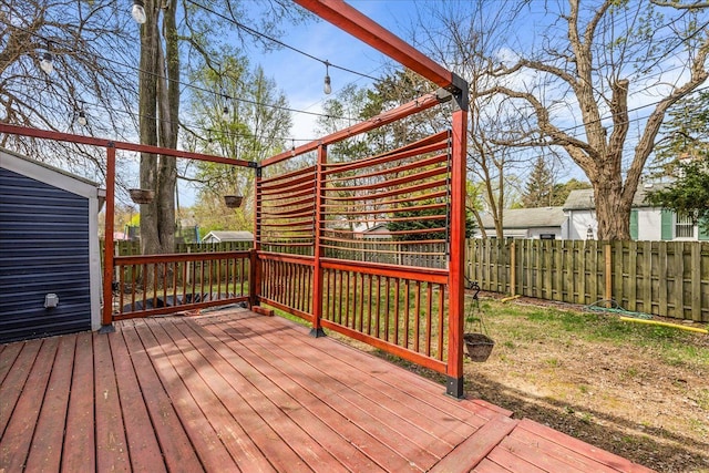 wooden deck featuring a fenced backyard