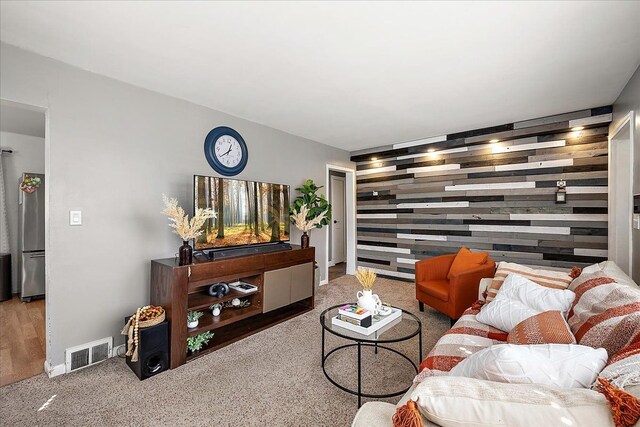 carpeted living room featuring visible vents