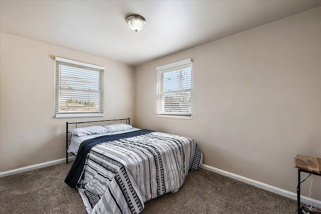 carpeted bedroom featuring baseboards