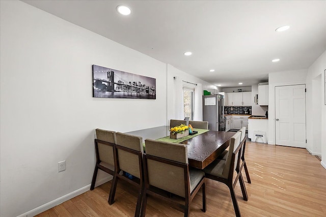 dining room featuring recessed lighting, light wood-style flooring, and baseboards