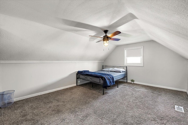 bedroom featuring a textured ceiling, baseboards, vaulted ceiling, and carpet floors