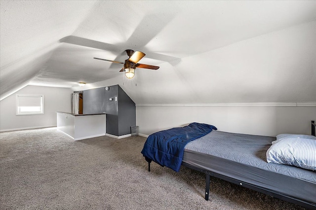 carpeted bedroom featuring lofted ceiling, a ceiling fan, and baseboards