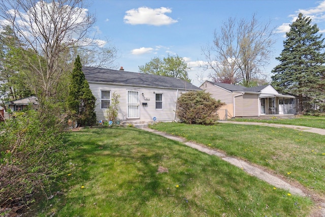 view of front of home featuring a front yard and a chimney