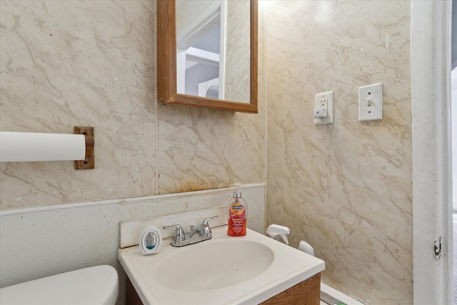 half bath featuring a sink and toilet
