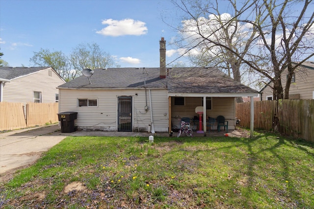 back of property featuring a patio area and a shingled roof