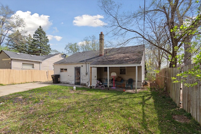 rear view of house with a patio and a chimney