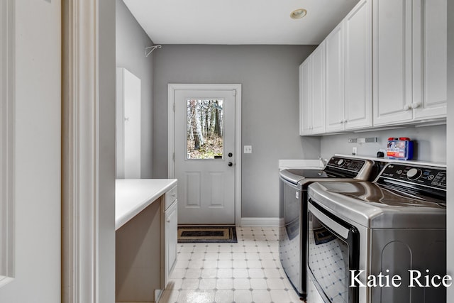 5575 Beechmont Rd, Whitehall, MI 49461 - clothes washing area with cabinet space, baseboards, washer and dryer, and light floors