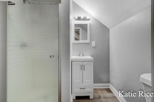 5575 Beechmont Rd, Whitehall, MI 49461 - bathroom featuring vaulted ceiling, wood finished floors, vanity, and a walk in shower
