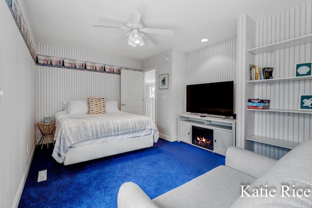5575 Beechmont Rd, Whitehall, MI 49461 - carpeted bedroom with a warm lit fireplace, baseboards, a ceiling fan, and wallpapered walls