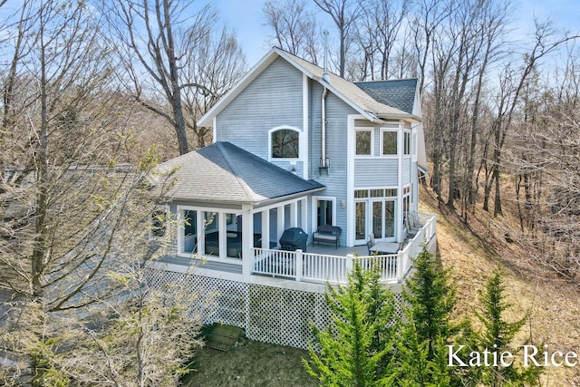5575 Beechmont Rd, Whitehall, MI 49461 - back of house featuring a wooden deck, a sunroom, and roof with shingles